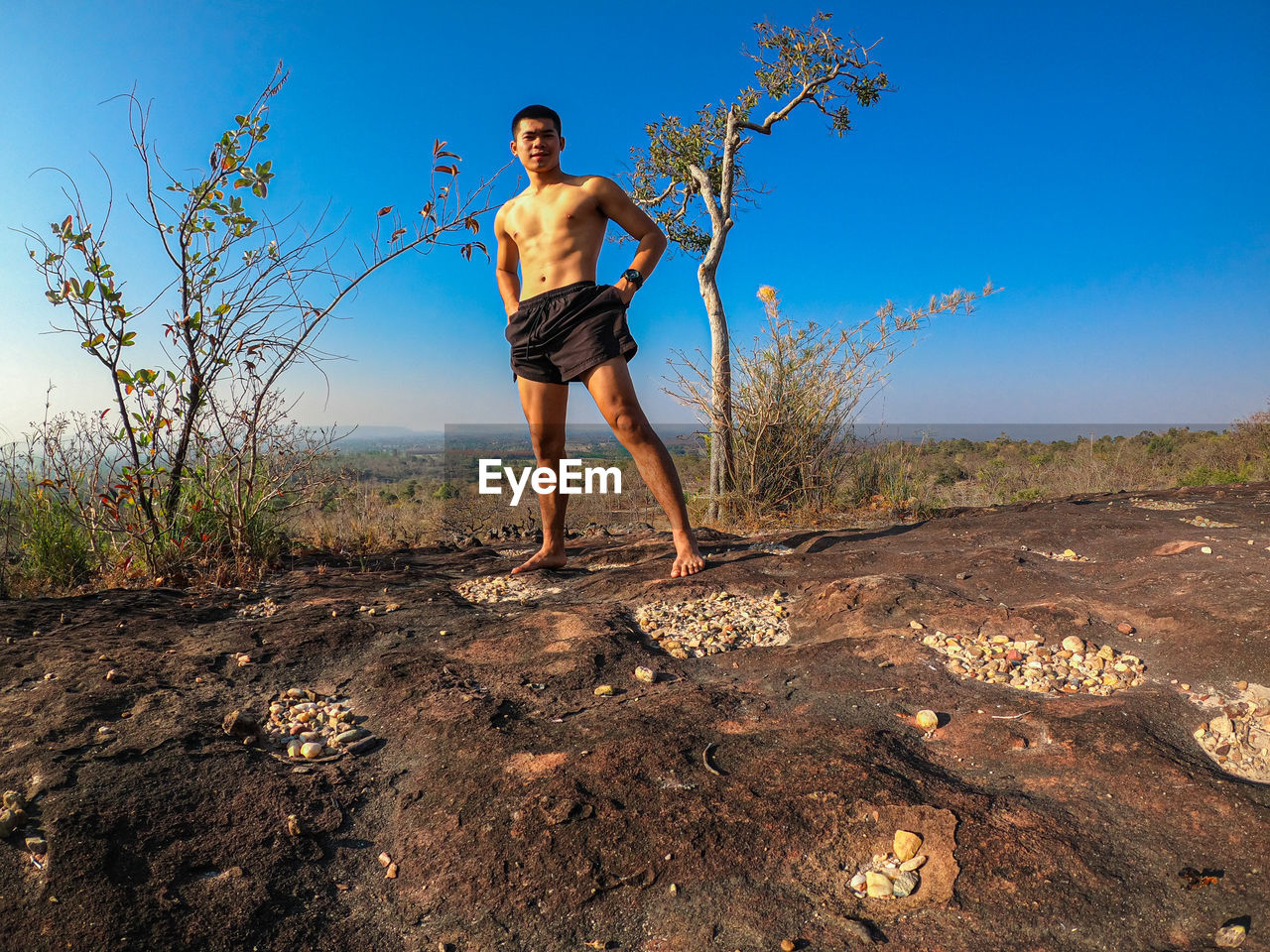 Full length of man standing on field against sky