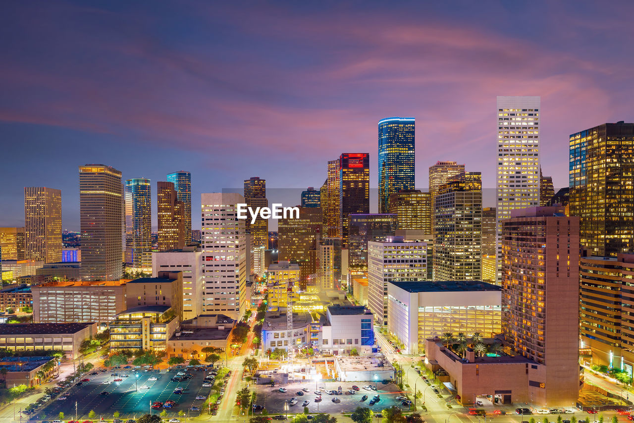 ILLUMINATED BUILDINGS AGAINST SKY IN CITY