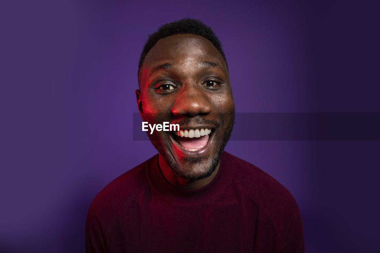 PORTRAIT OF A SMILING YOUNG MAN