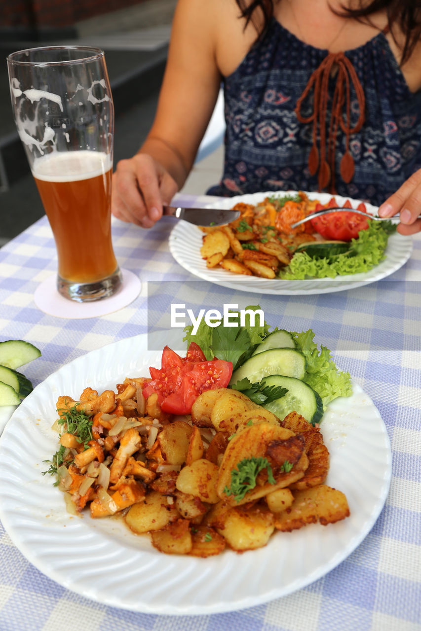 Close-up of woman having food on table