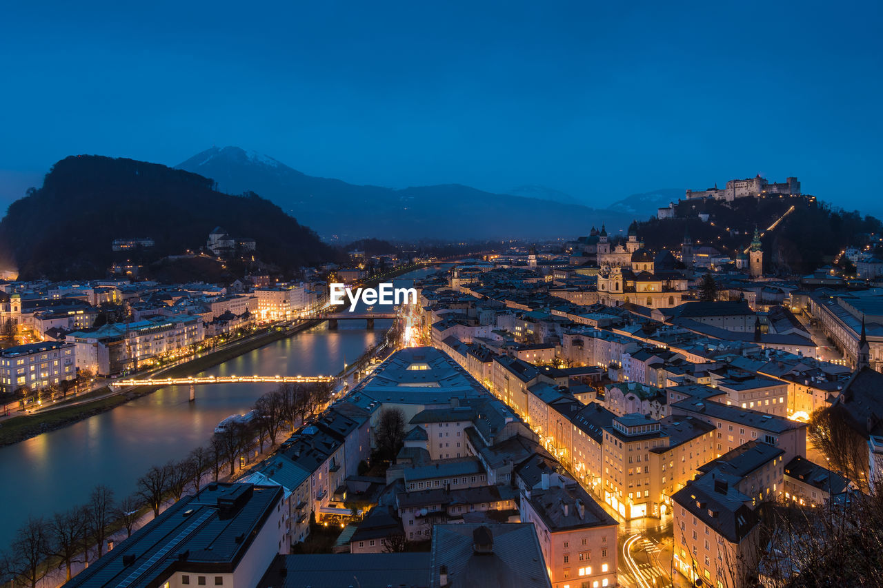 High angle view of city lit up at night