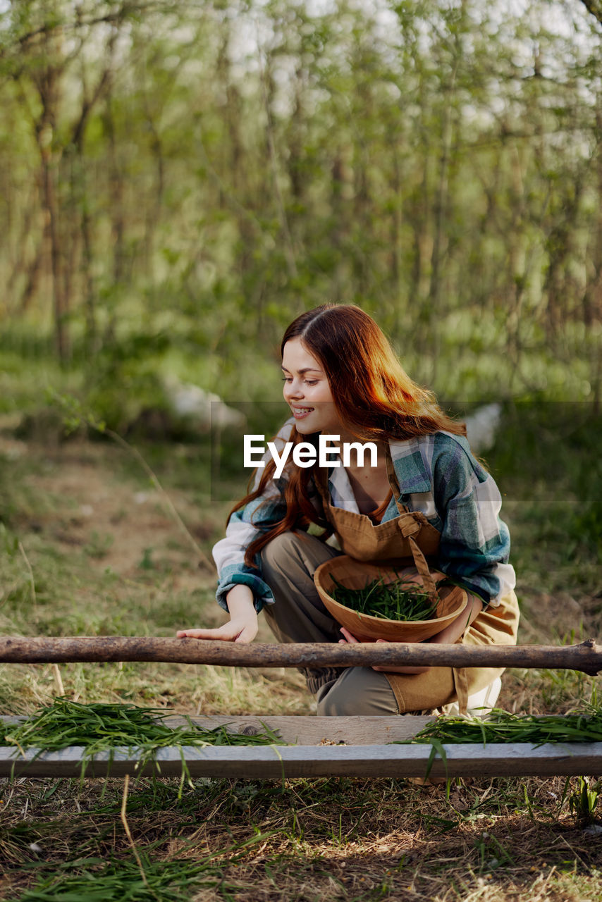 Young woman with bowl at farm