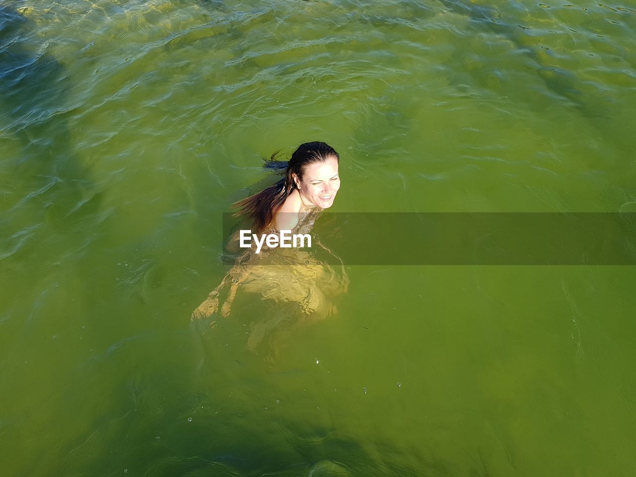 High angle view of woman swimming in water