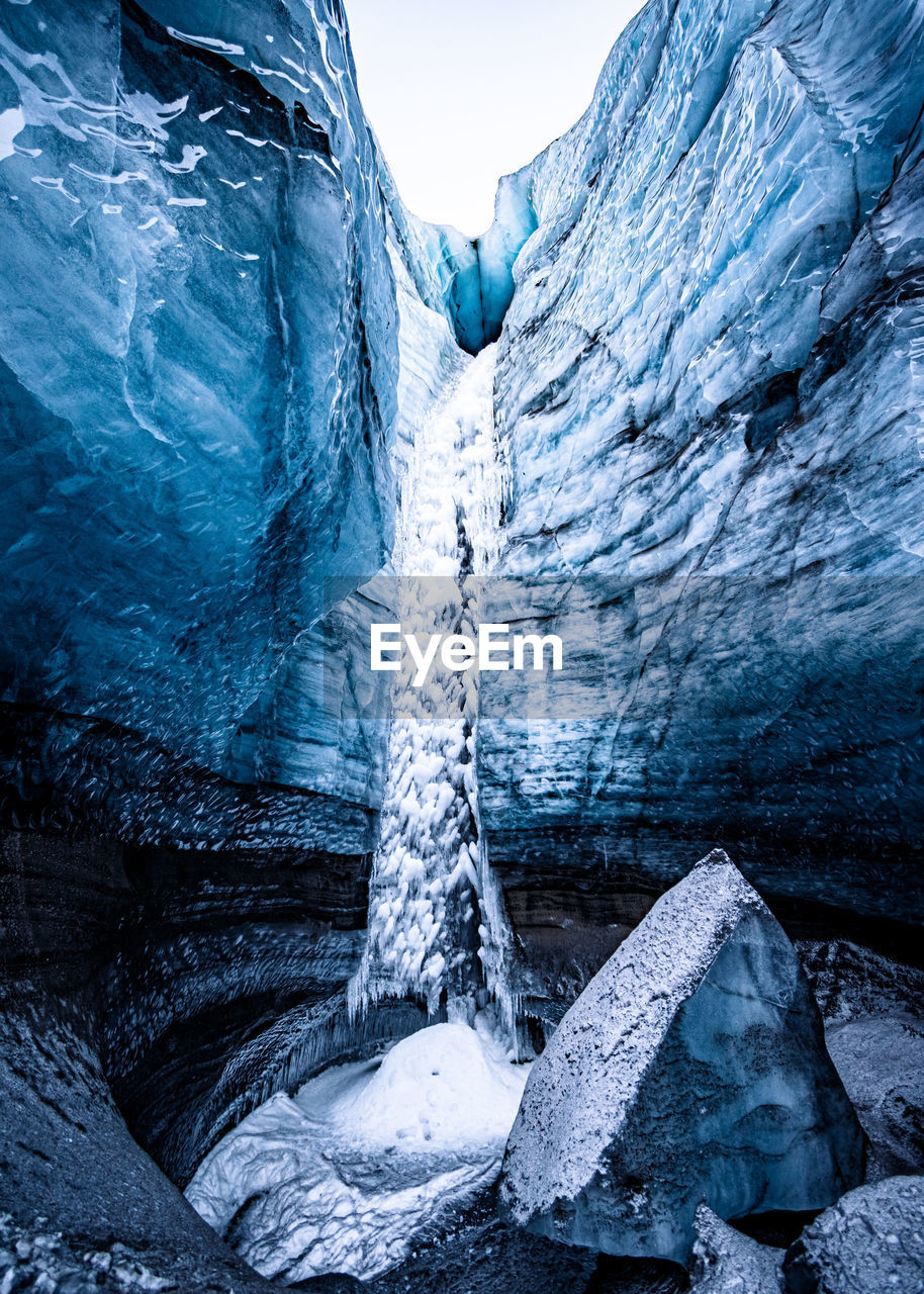 ICICLES ON SNOW COVERED MOUNTAIN