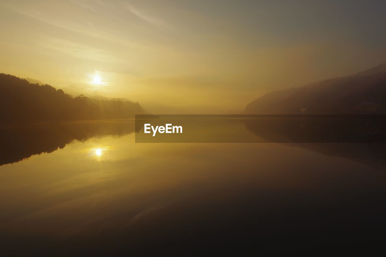 LAKE AGAINST SKY DURING SUNSET