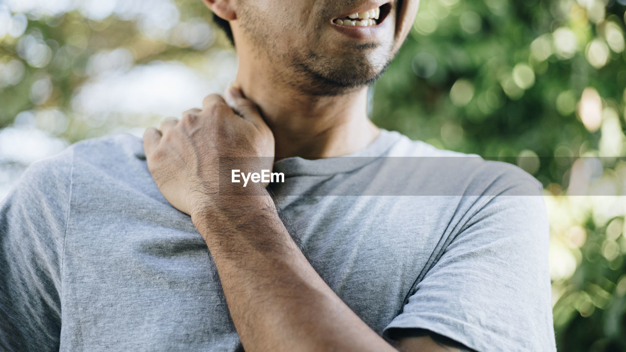 PORTRAIT OF YOUNG MAN WITH TATTOO ON PLANT