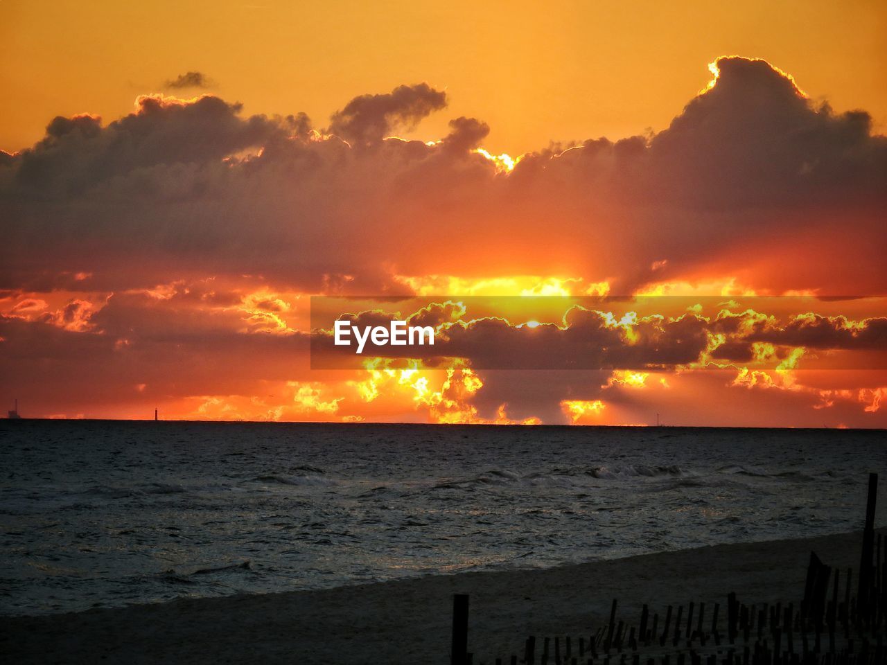 SCENIC VIEW OF BEACH AGAINST SKY DURING SUNSET