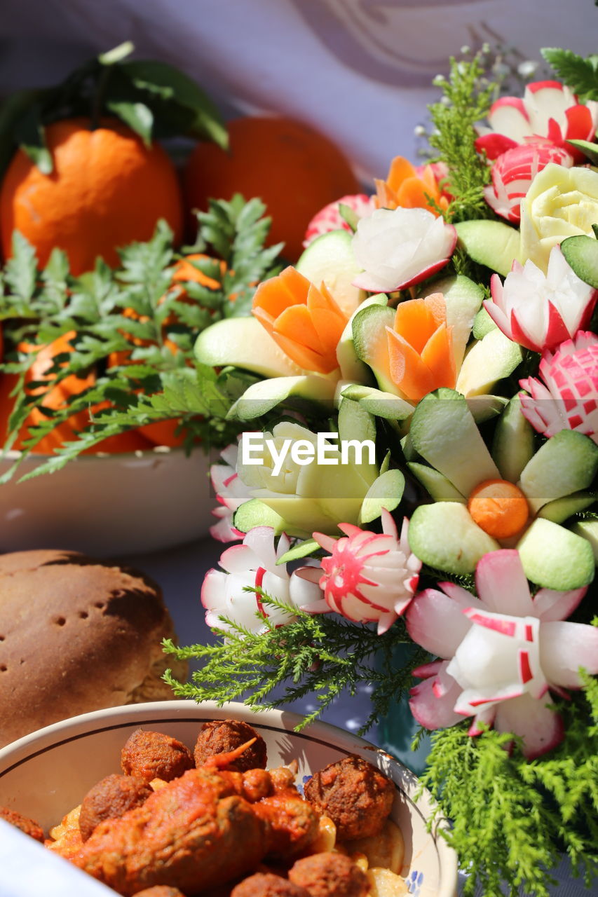 Close-up of food served on table with vegetable decoration