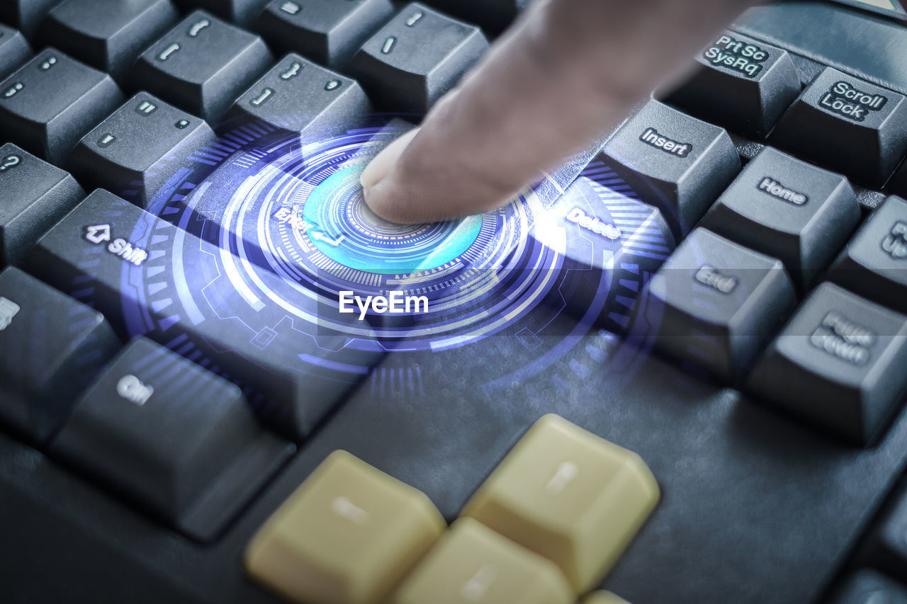 Digital composite image of finger pressing keyboard button