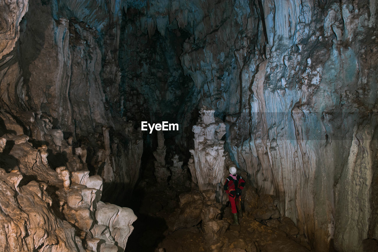 Rear view of man standing in cave