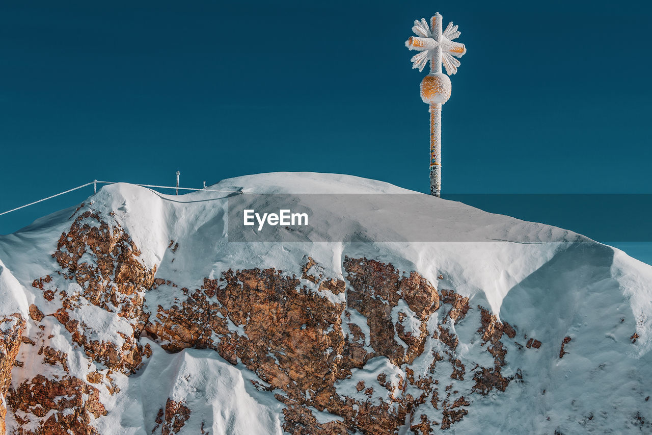 The summit cross on the zugspitze east summit, bavaria germany.