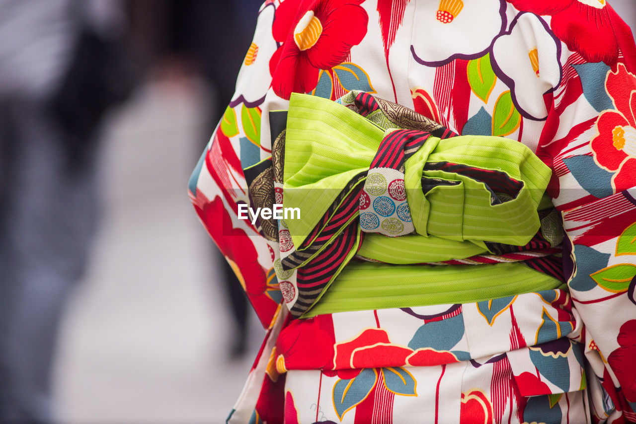 REAR VIEW OF WOMAN WITH RED UMBRELLA