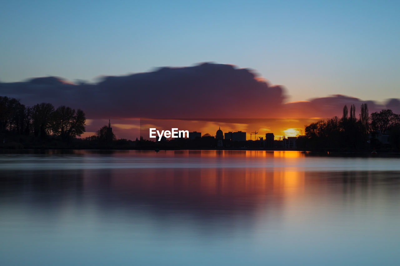 Silhouette of potsdam during sunset with the river havel