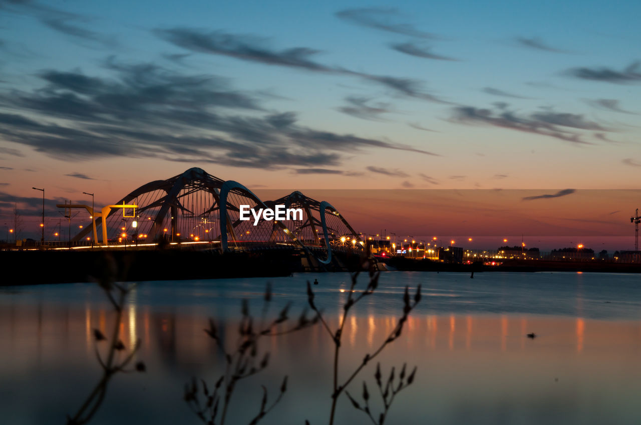 Enneus heerma bridge against sky during sunset in city