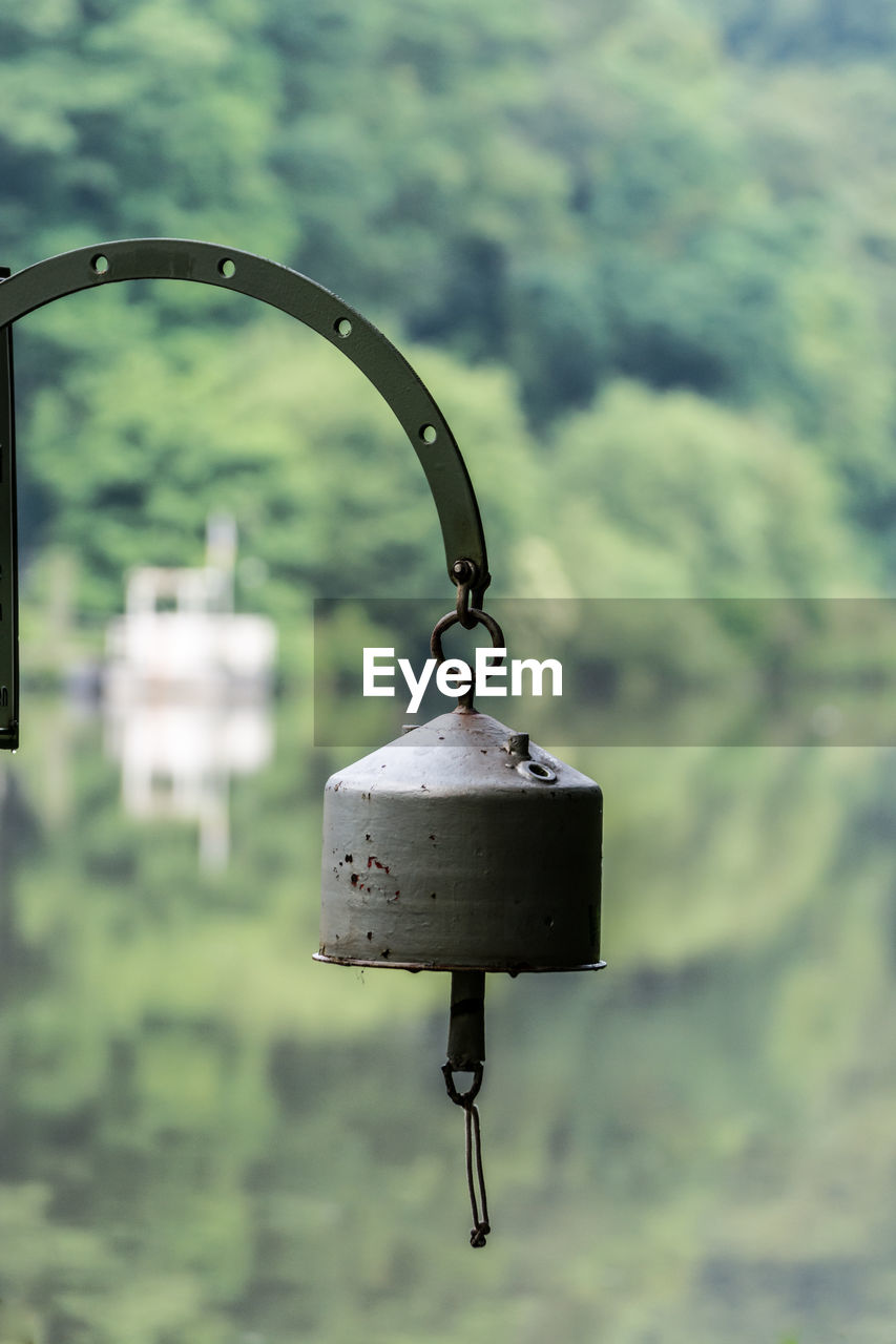 Metal bell hanging against mountain