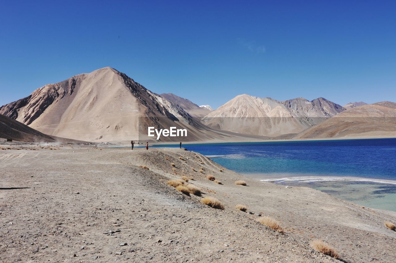 Scenic view of mountains against clear blue sky