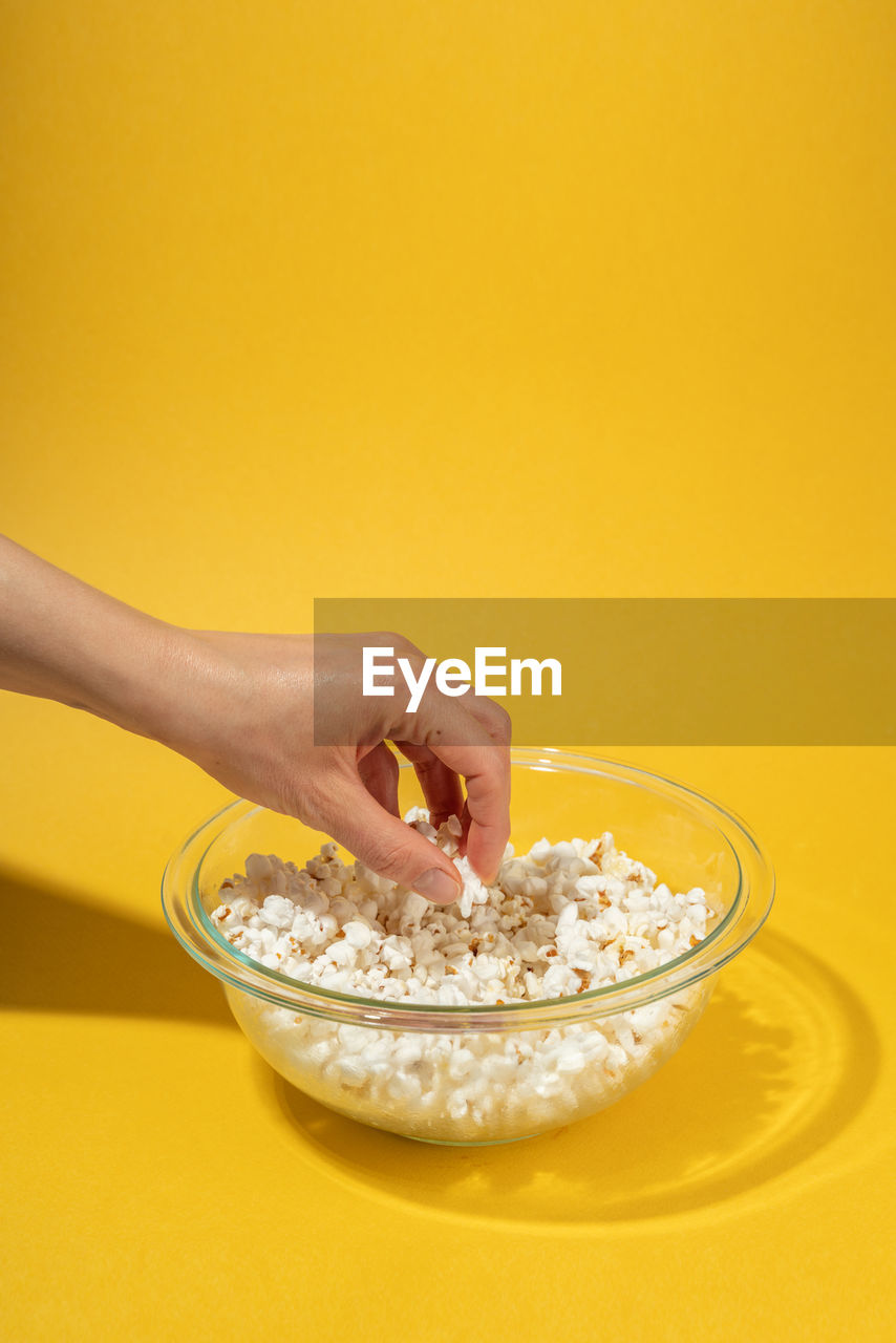 MIDSECTION OF WOMAN HOLDING BOWL