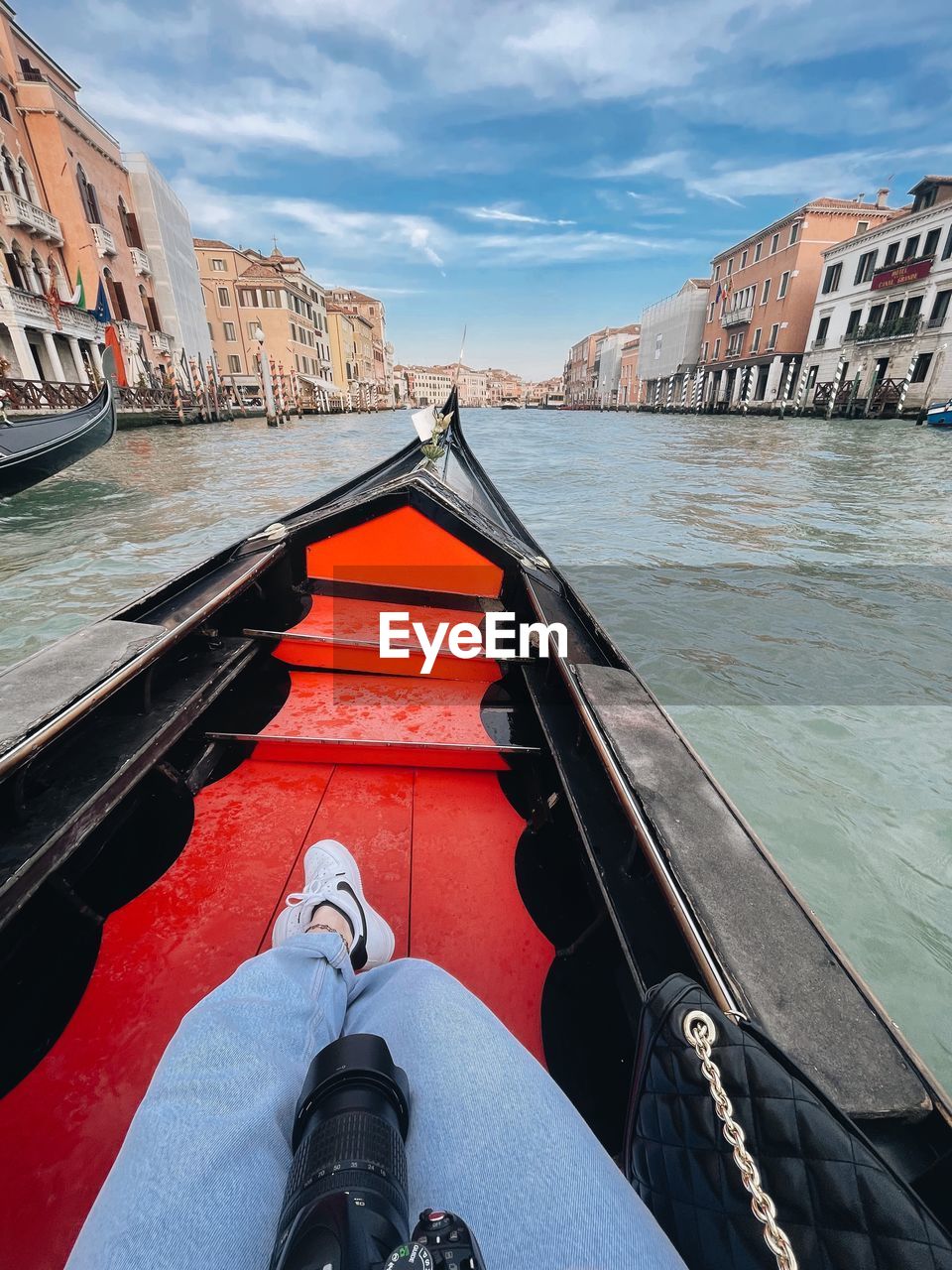 LOW SECTION OF MAN ON BOAT IN CANAL