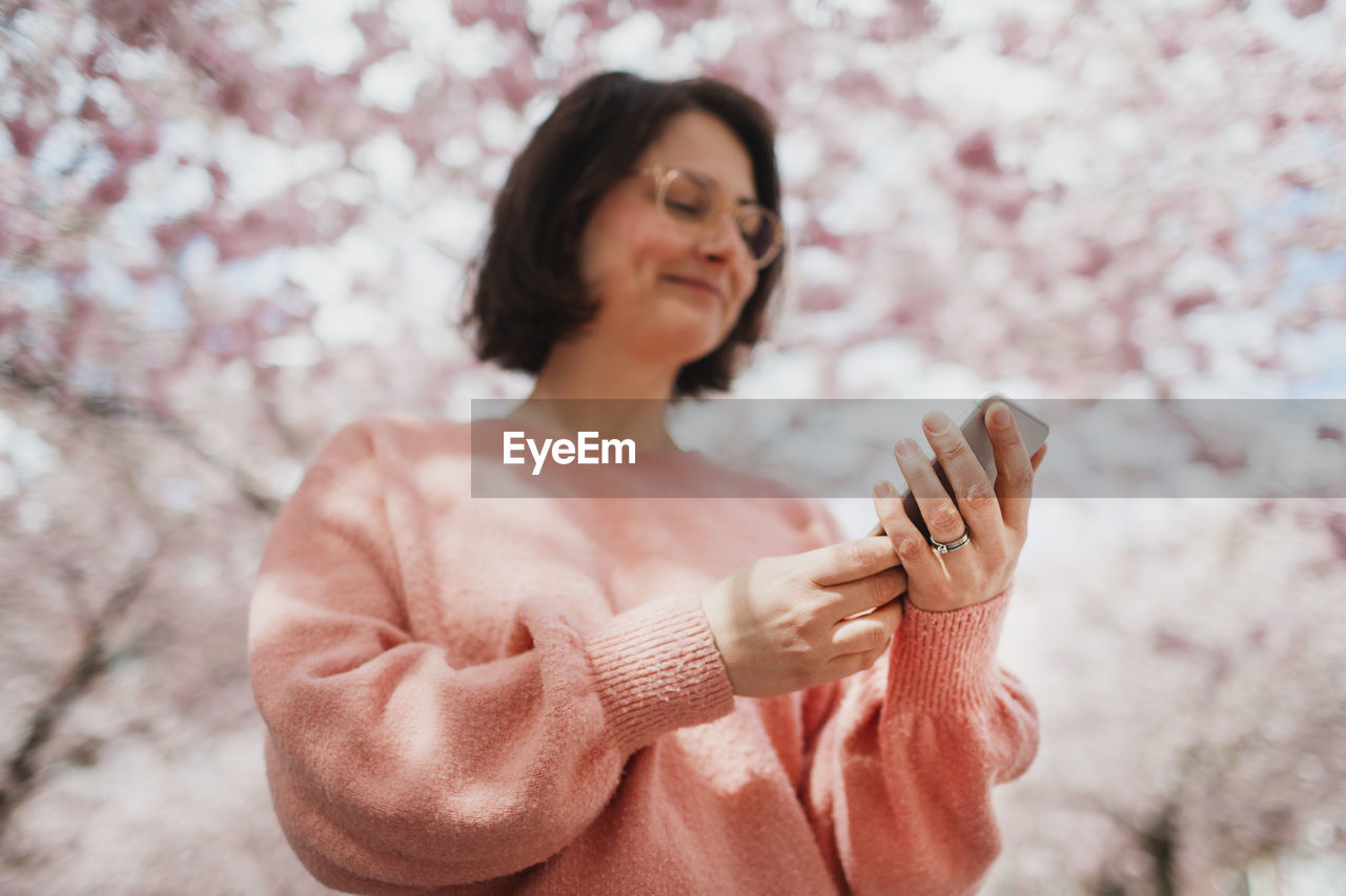 Womans hands holding cell phone