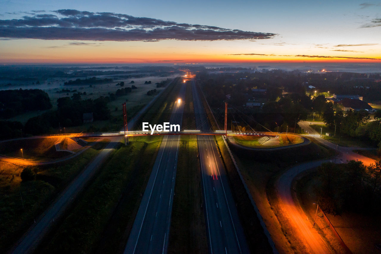 High angle view of light trails on highway during sunset