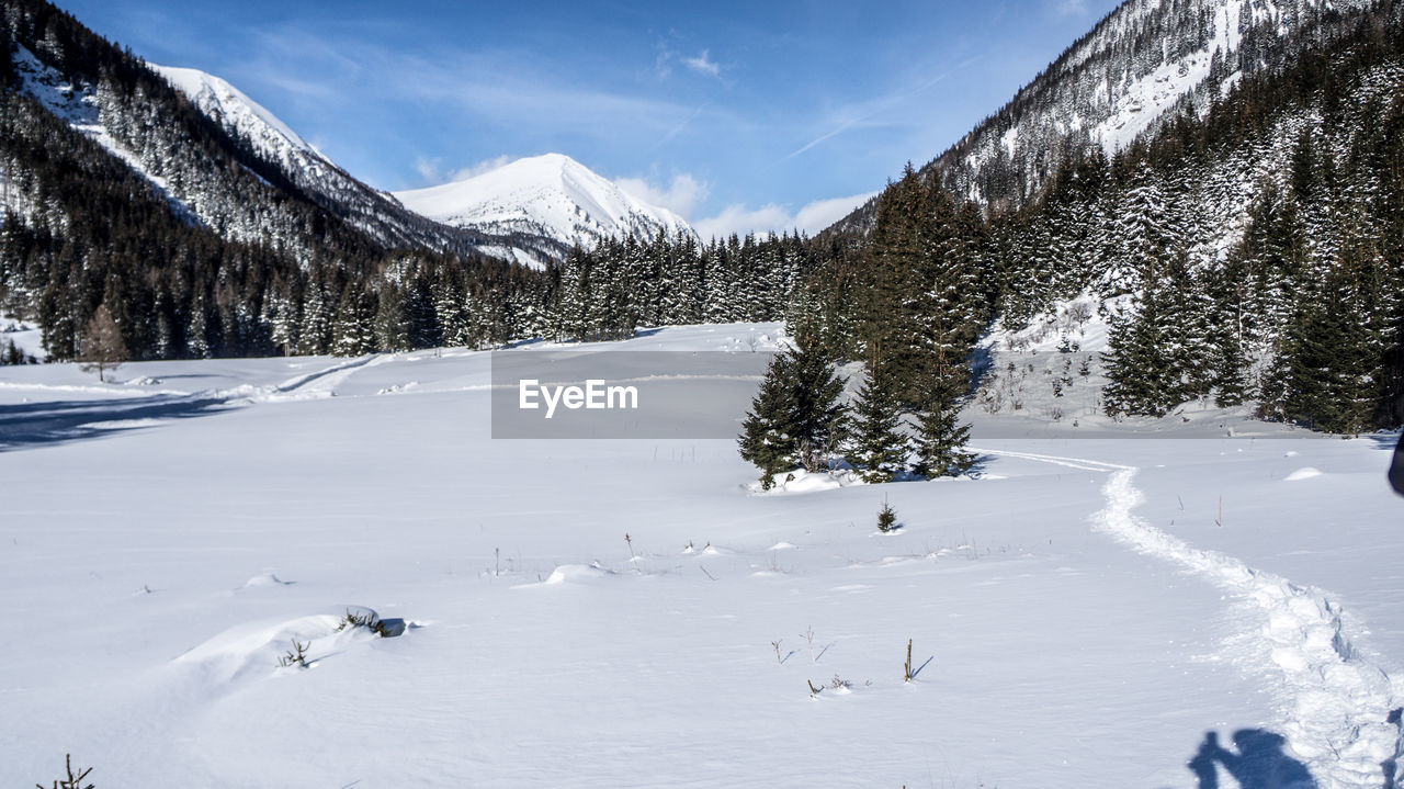 Scenic view of snow covered mountains against sky