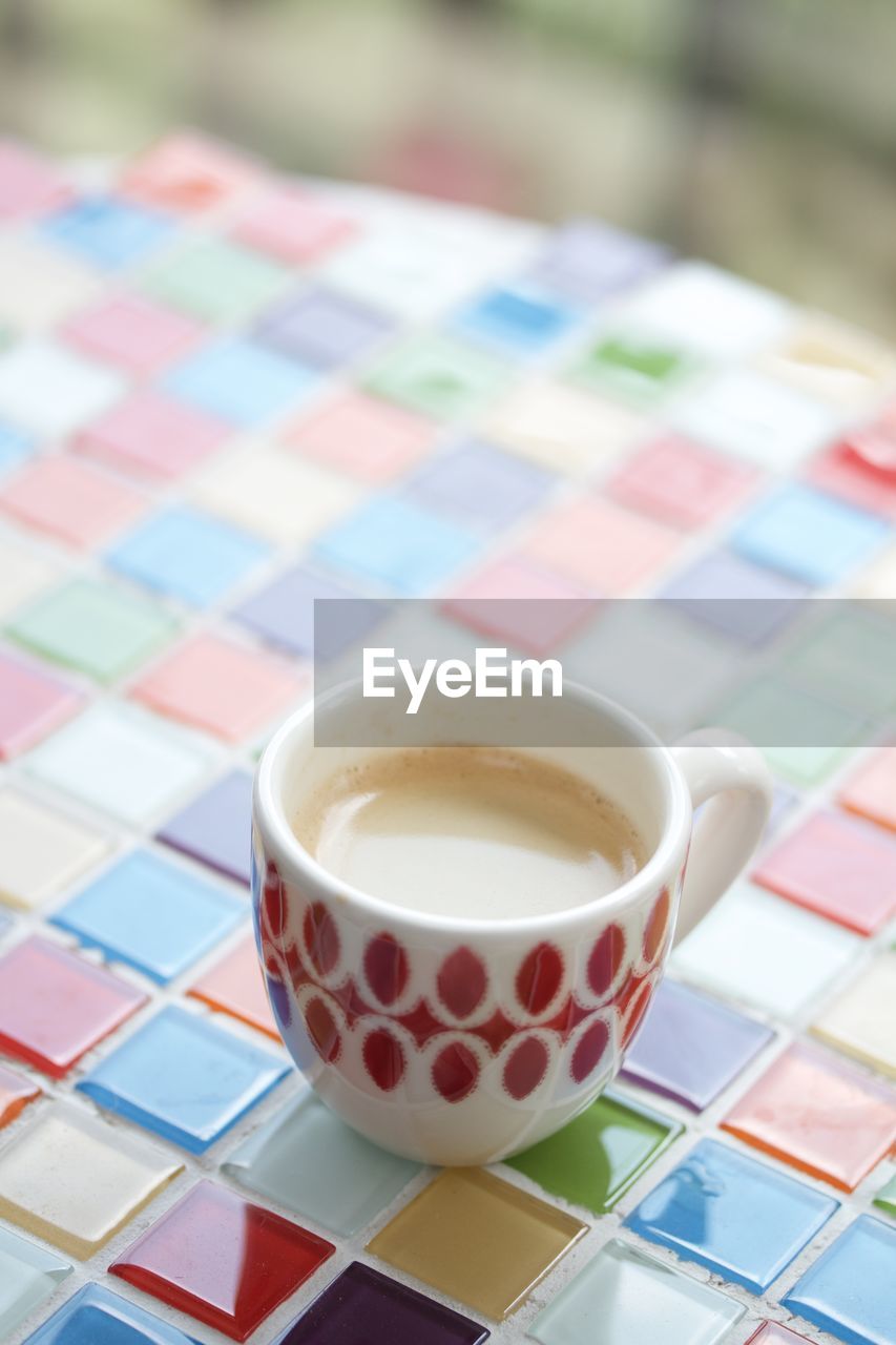 CLOSE-UP OF COFFEE CUP ON TABLE