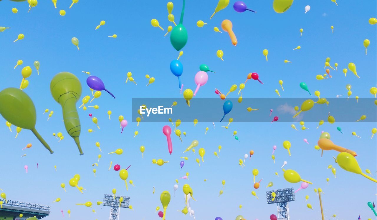 LOW ANGLE VIEW OF BALLOONS FLYING IN SKY