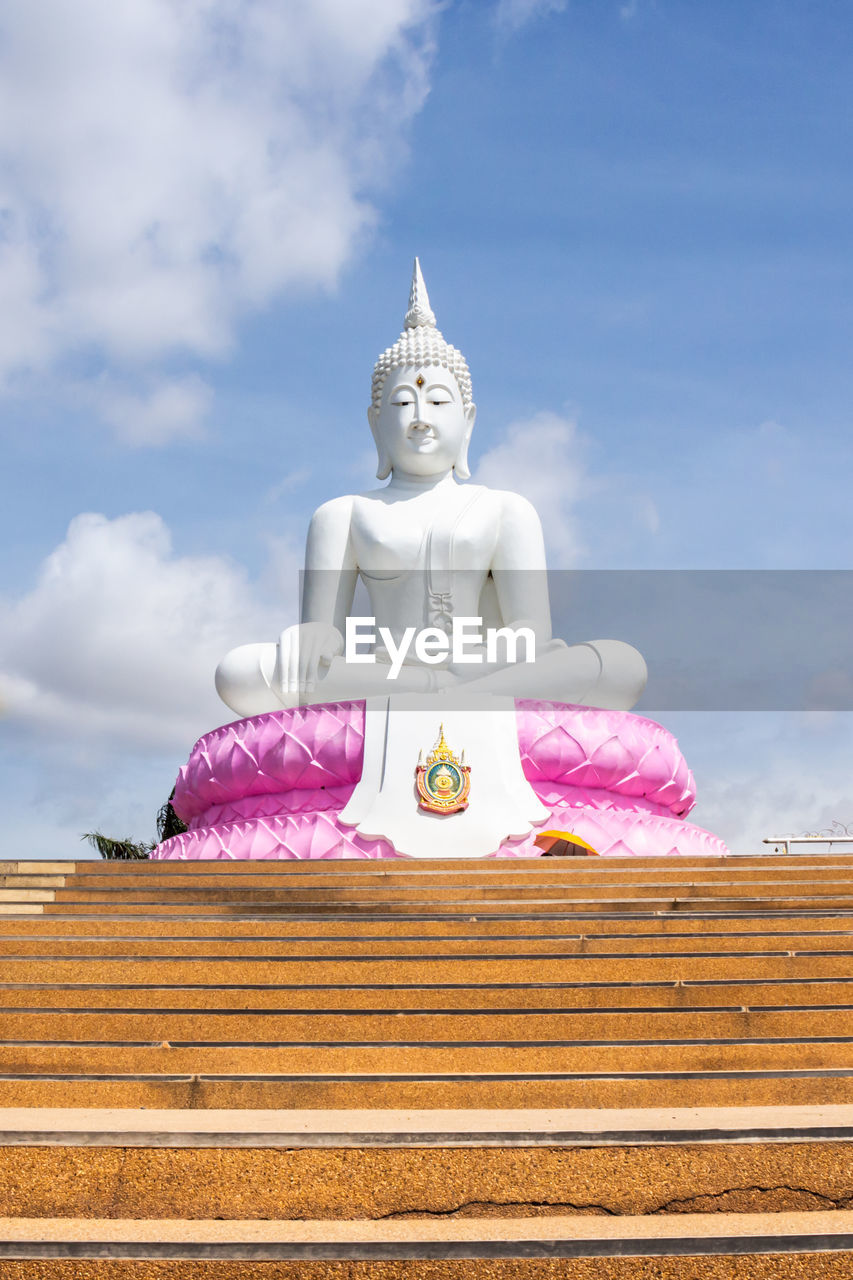 LOW ANGLE VIEW OF STATUE OF BUDDHA AGAINST SKY