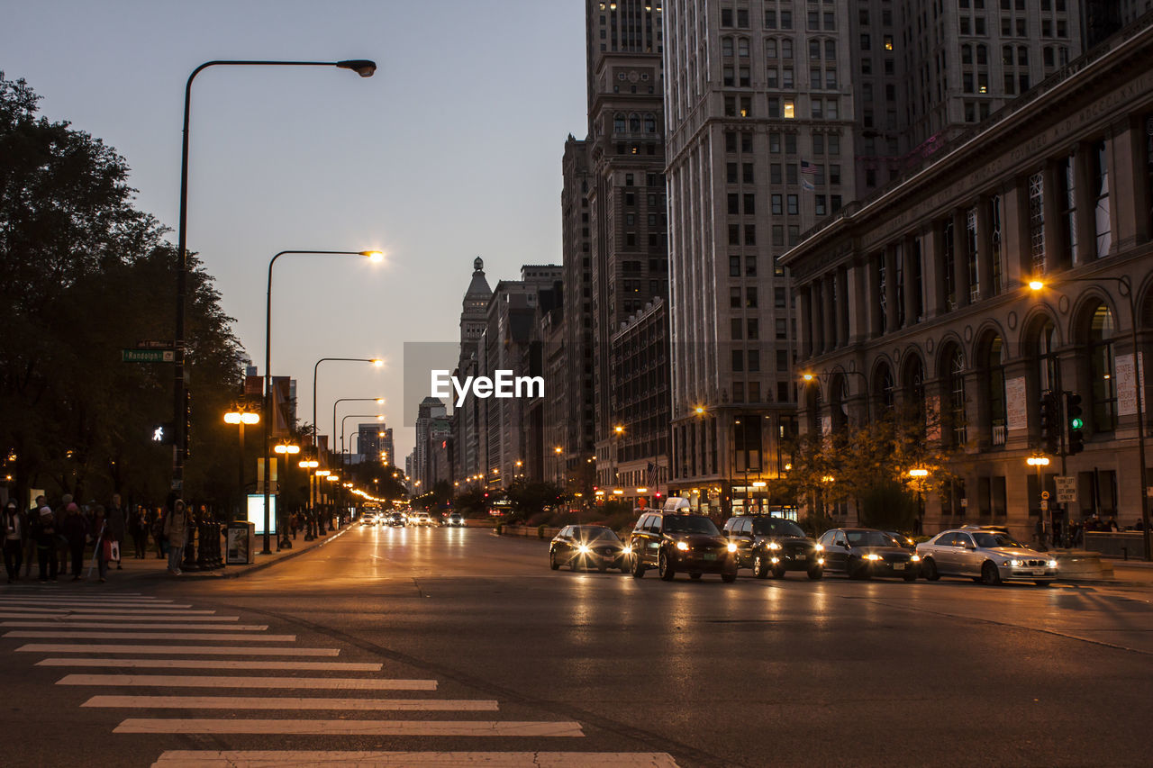 Illuminated city street and buildings at night