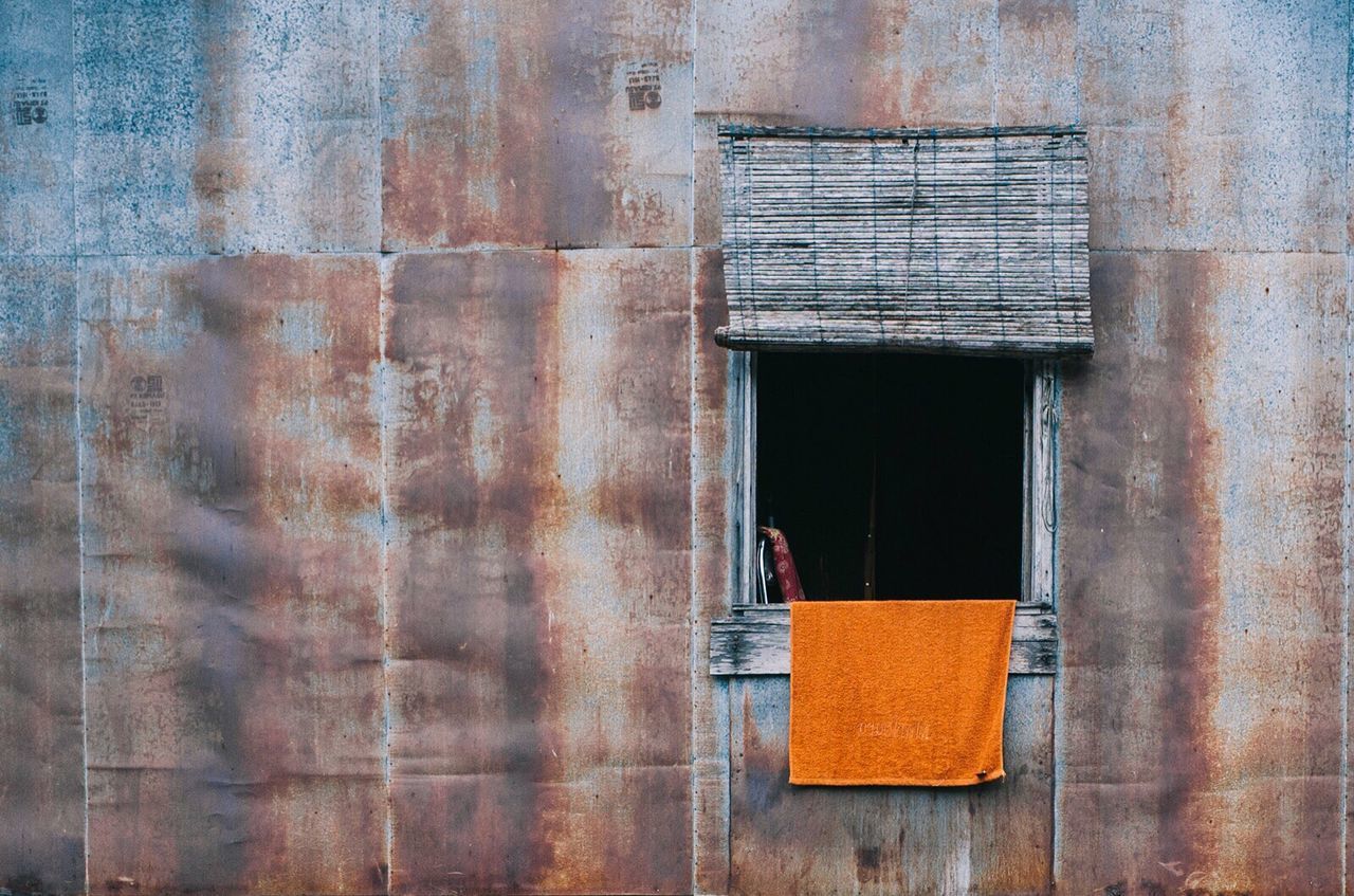 CLOSE-UP OF BRICK WALL WITH BUILDING