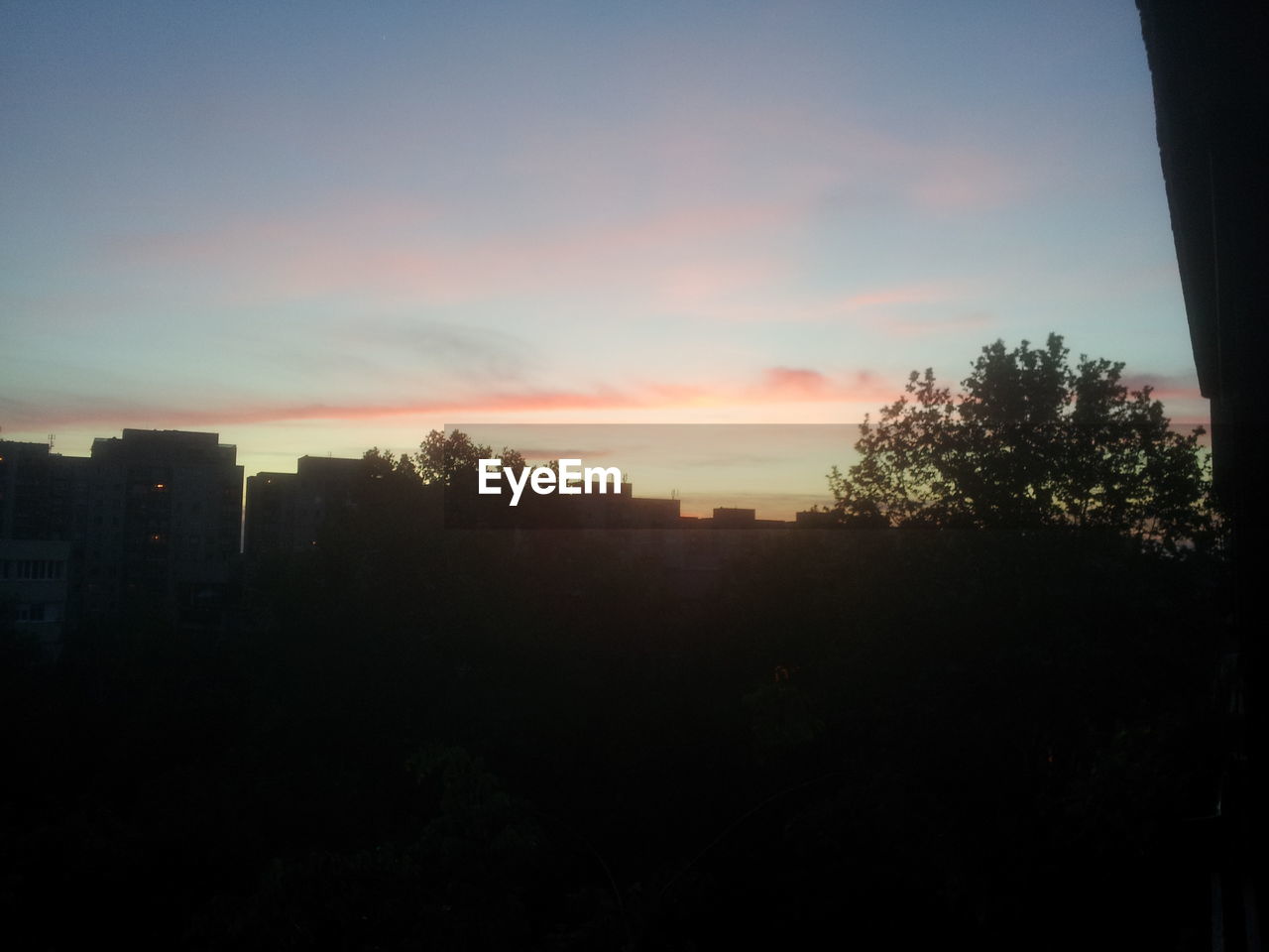 SILHOUETTE OF BUILDINGS AT SUNSET