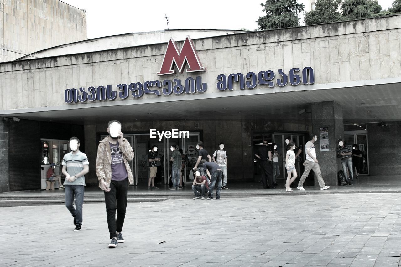 MAN STANDING ON RAILROAD STATION