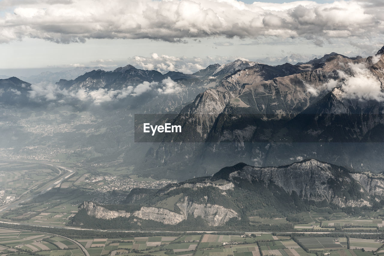 Aerial view of snowcapped mountains against sky