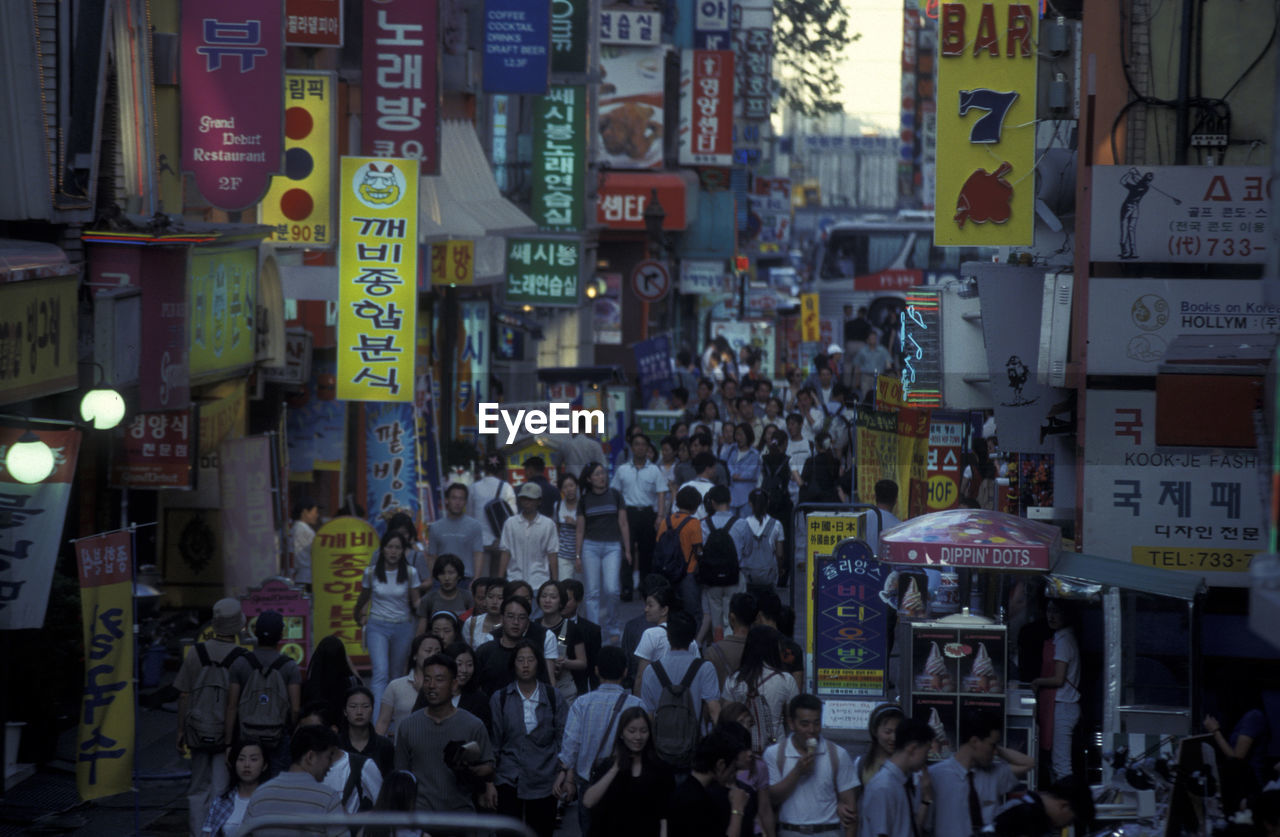 GROUP OF PEOPLE IN FRONT OF CITY