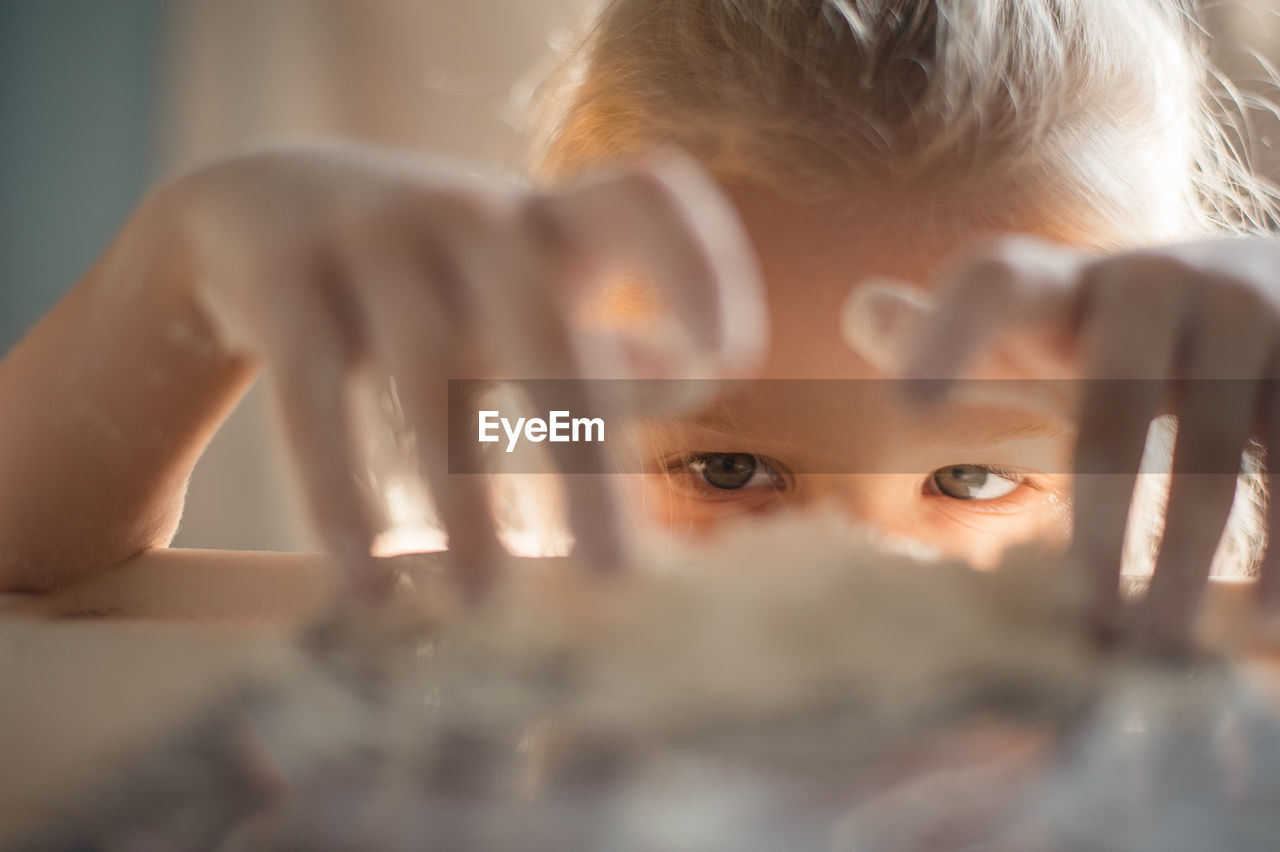 Close-up of girl playing by table