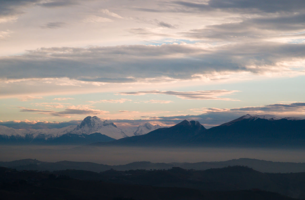 Scenic view of silhouette mountains against sky during sunset