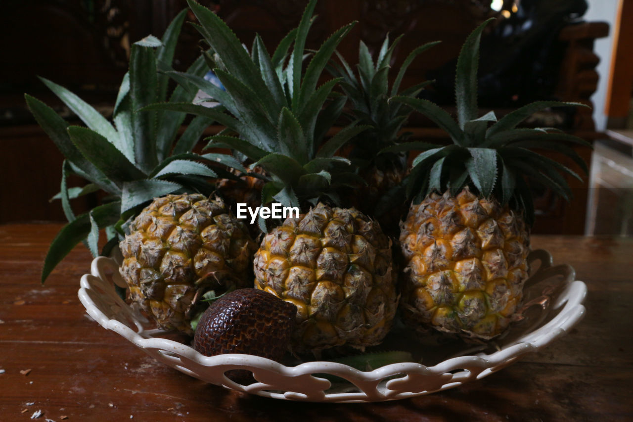 pineapple, ananas, food and drink, food, fruit, healthy eating, bromeliaceae, produce, plant, tropical fruit, freshness, wellbeing, indoors, no people, wood, table, nature