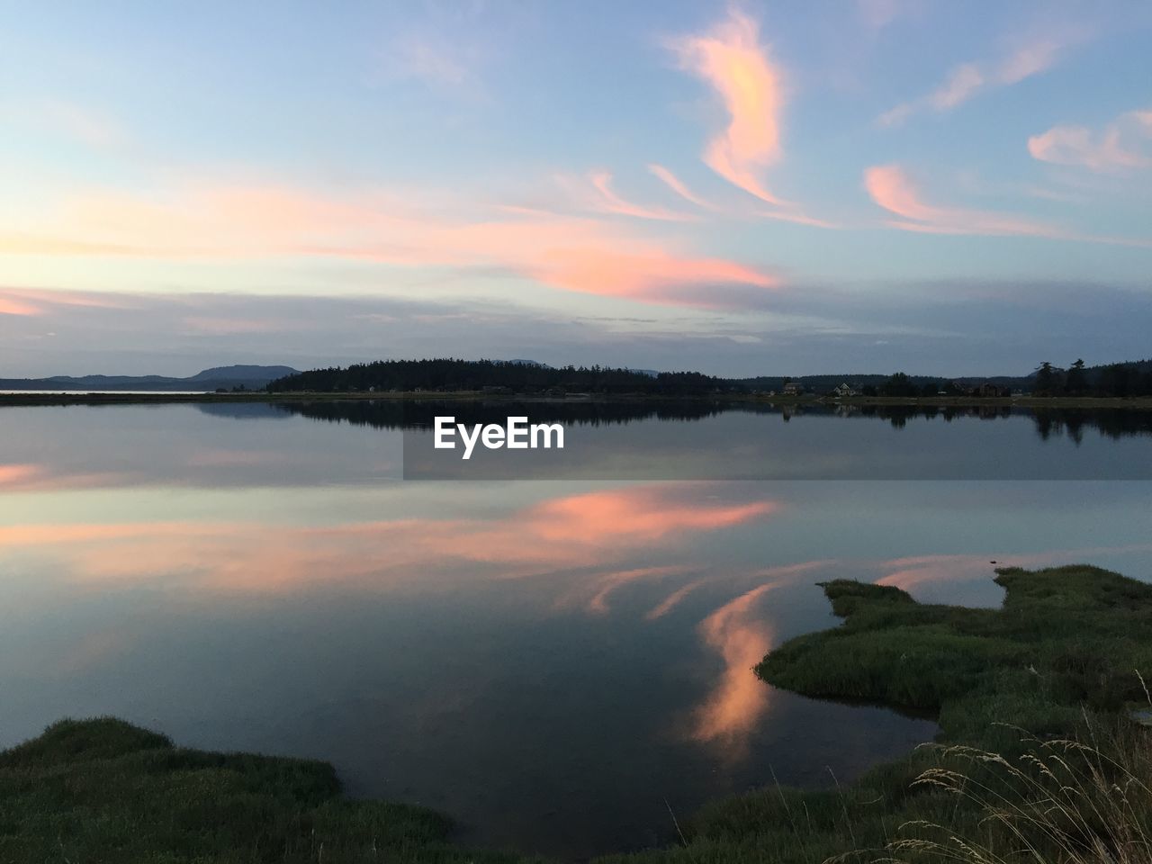 Scenic view of lake against sky during sunset