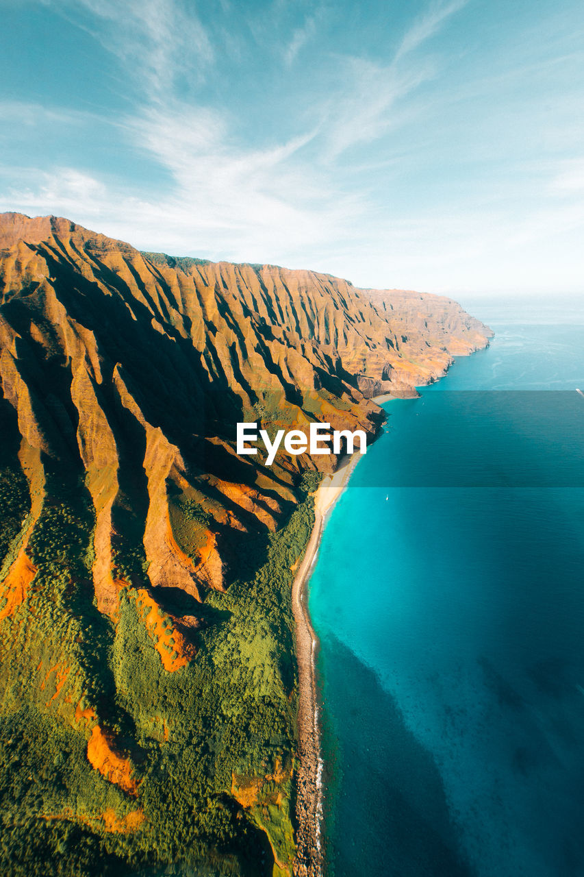 HIGH ANGLE VIEW OF BAY WATER AGAINST CLOUDY SKY