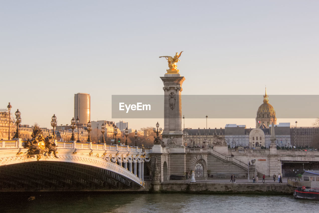 View of pont alexandre iii and les invalides at sunset in paris, france