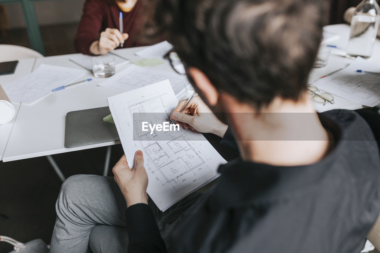 High angle view of businessman planning strategy during meeting at office