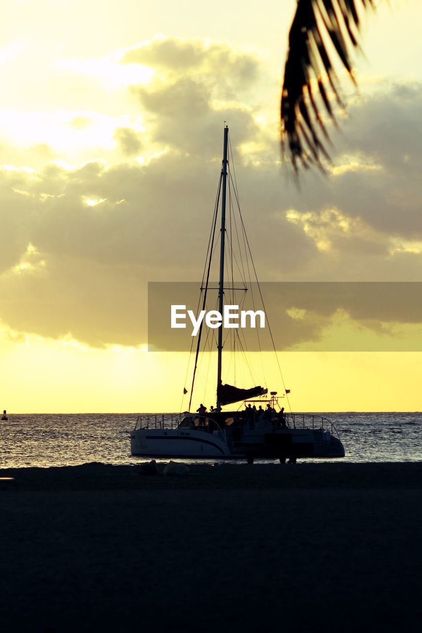 Silhouette sailboat on sea against sky during sunset