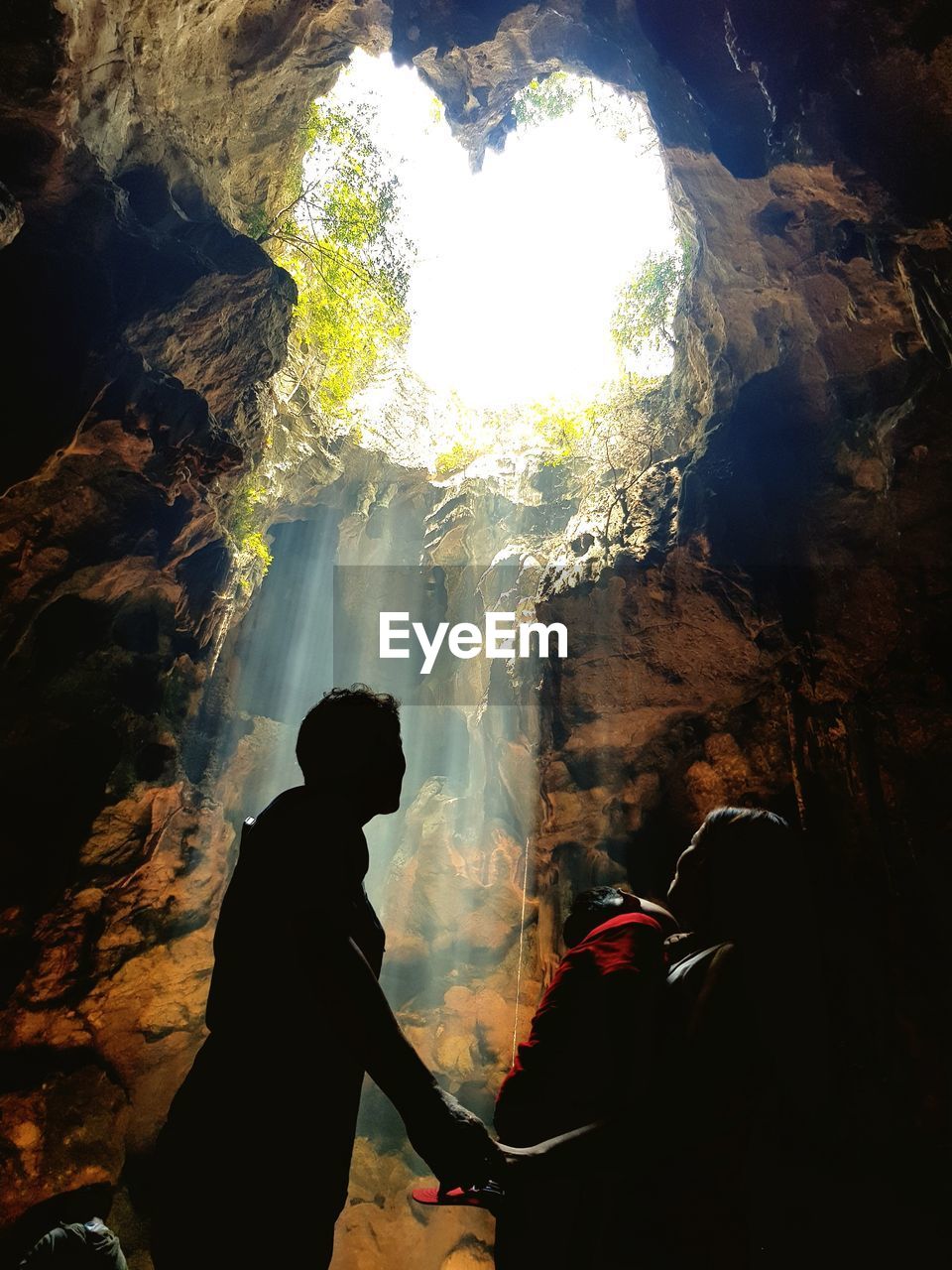 PEOPLE STANDING IN CAVE