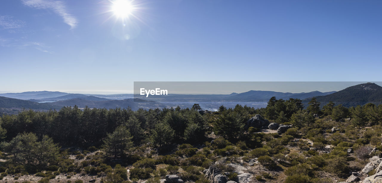 Scenic view of mountains against sky on sunny day