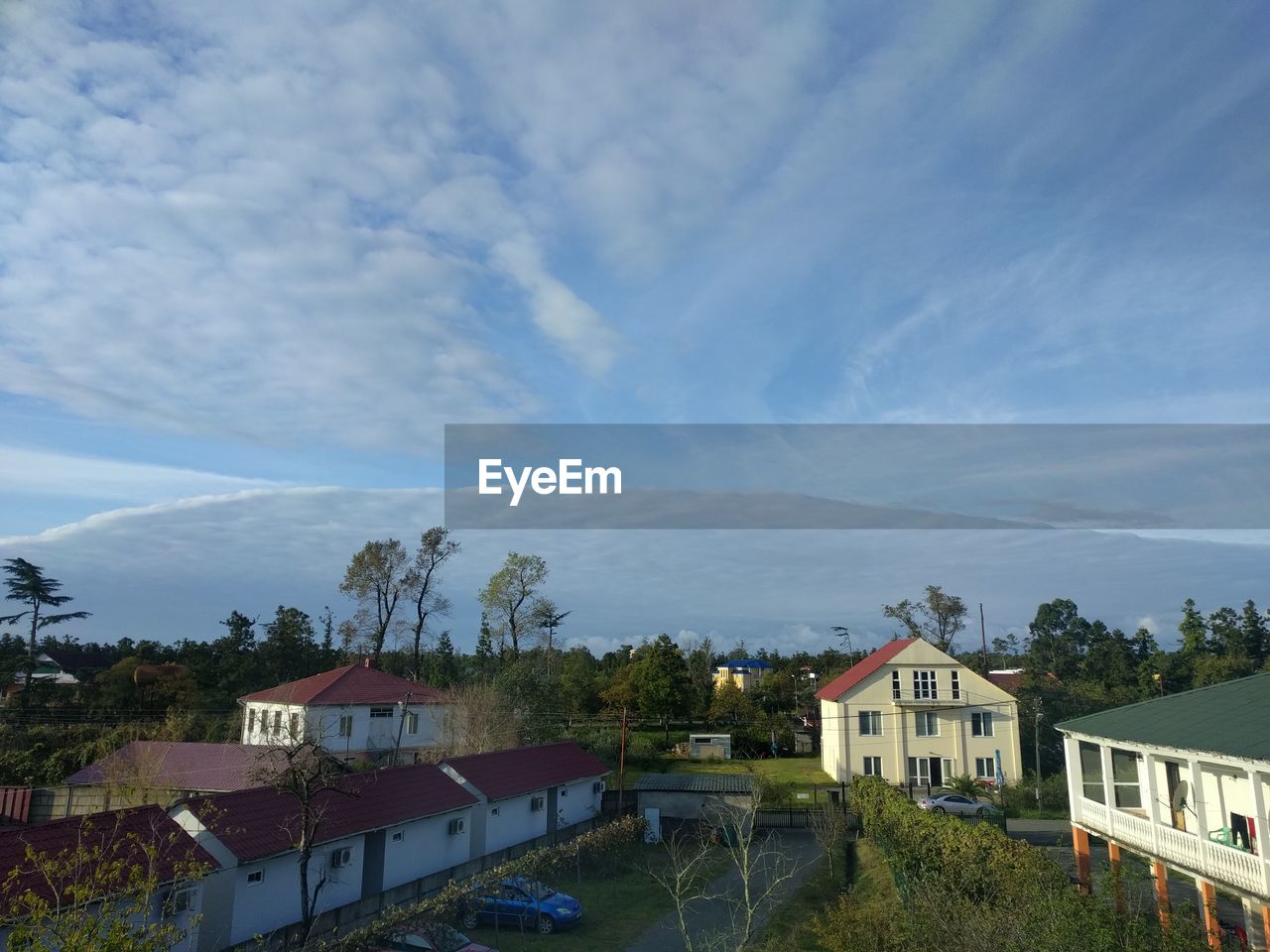 High angle view of buildings and houses against sky