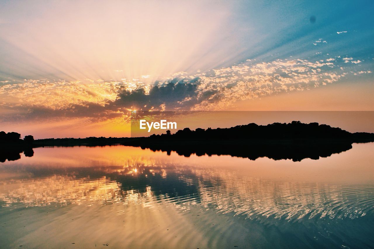 Scenic view of lake at sunset