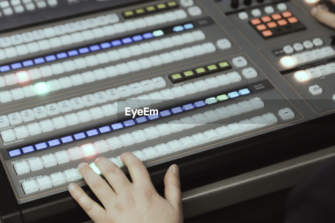 Cropped hands mixing music in recording studio