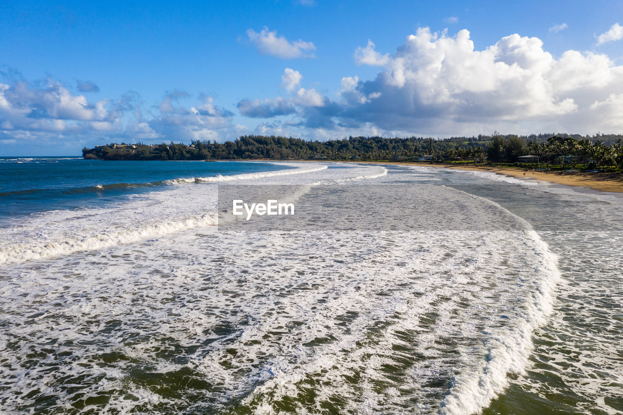 Aerial panoramic image at sunrise off the coast over hanalei bay and waioli beach park on kauai