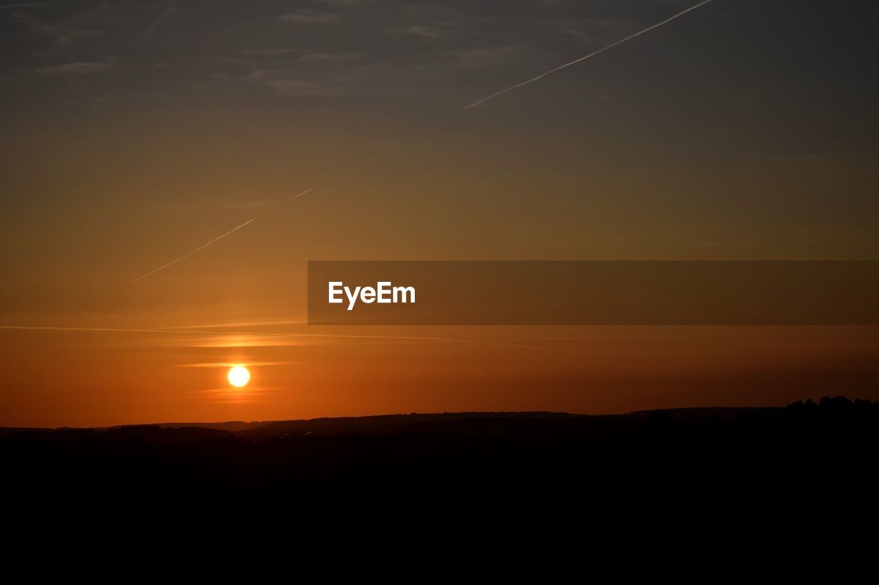 Silhouette landscape against sky during sunset