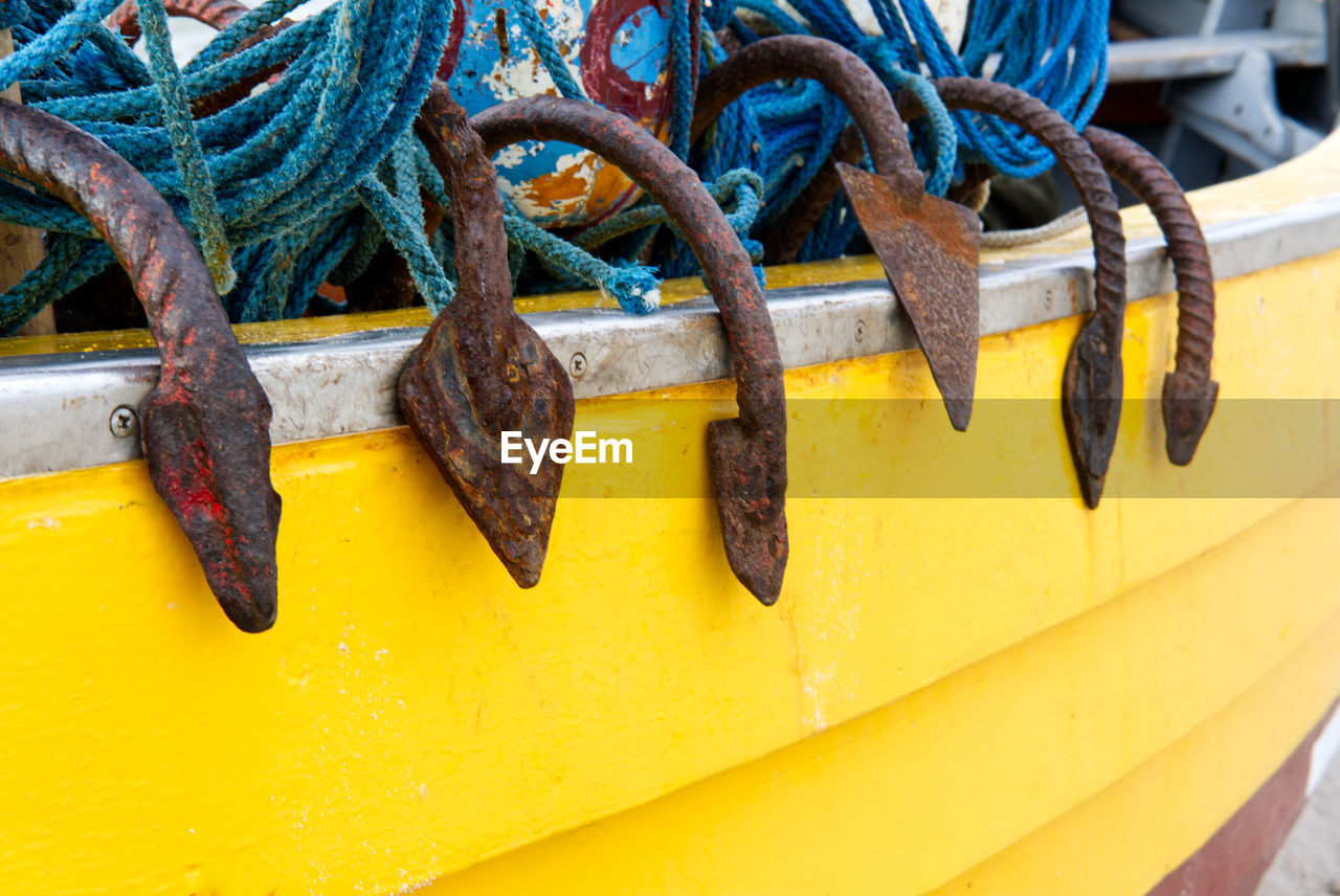 CLOSE-UP OF ROPES ON RUSTY METAL